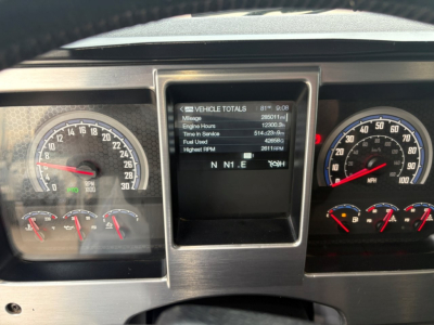Dashboard of a 2020 Mack GR64F showing multiple gauges and a central digital readout with vehicle totals.