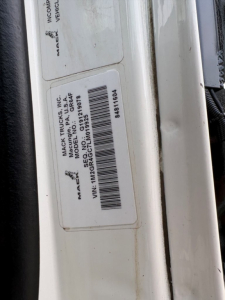 Label showing VIN and stock information on Mack truck. Visible text includes: MACK TRUCKS INC, MODEL GA BEF? (label mostly), VIN: 1M2GR4GC7LM019925, STOCK NO: B3429P, MADE IN U.S.A. MACK TRUCKS INC.