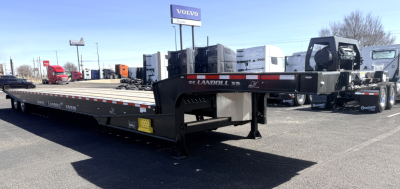 Landoll 440B-53 40-ton traveling axle lowboy trailer showing long flatbed and reinforced gooseneck area, front label and wheels in the background.