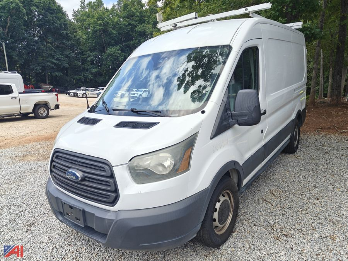 Ford Transit full-size cargo van in white with roof rack, front grille, and side mirror view.