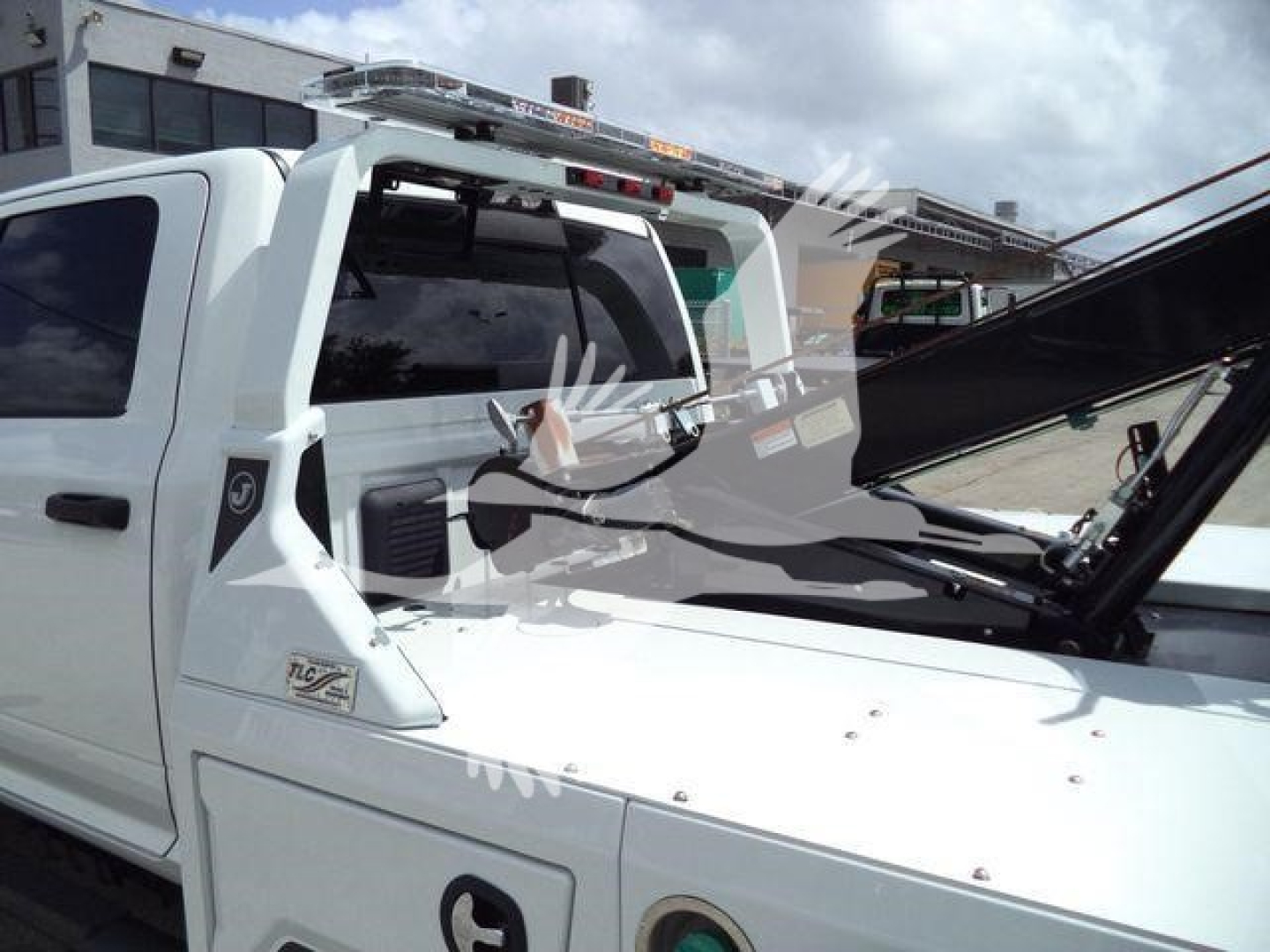 Ram 5500 Big Horn pickup truck with custom equipment and winch, white exterior, windshield wipers, and equipment rack on roof.