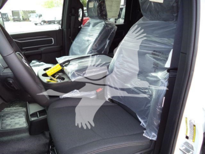 Ram 5500 Big Horn interior view with front seats wrapped in plastic, steering wheel, and center console visible.