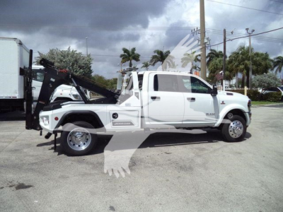 Ram 5500 Big Horn tow truck side view with wheel-lift system and white cab.