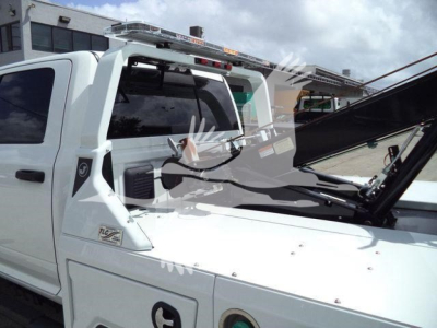 Ram 5500 Big Horn pickup truck with custom equipment and winch, white exterior, windshield wipers, and equipment rack on roof.