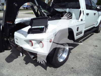 Ram 5500 tow truck rear side showing winch and hydraulic system with white exterior and dual rear wheel, J25599 stock number.