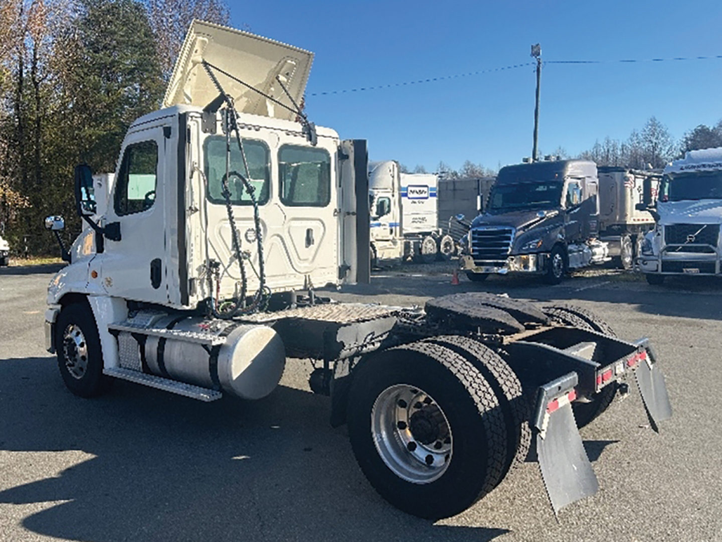 Truck chassis with cab over Freightliner Cascadia125, mid-drift view shows rear chassis and wheel hubs.