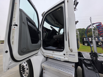 Kenworth T880 cab interior visible through open door; steps with metal tread plate; VIN and stock label area not legible; exterior door frame and side panel; truck cab interior dash visible