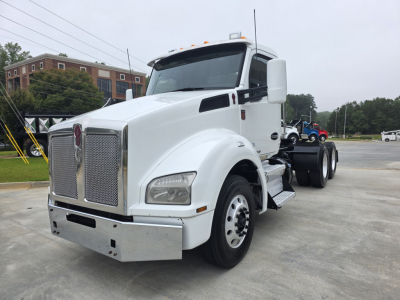 Kenworth T880 tractor in white, front-left view showing grille, headlights, bumper, and side steps; no text visible on components.