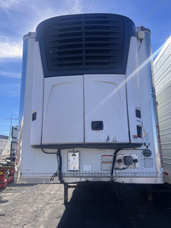 Great Dane air ride reefer trailer refrigeration unit front view with white body and black grille, VIN plate area visible