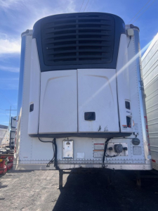 Great Dane air ride reefer trailer refrigeration unit front view with white body and black grille, VIN plate area visible