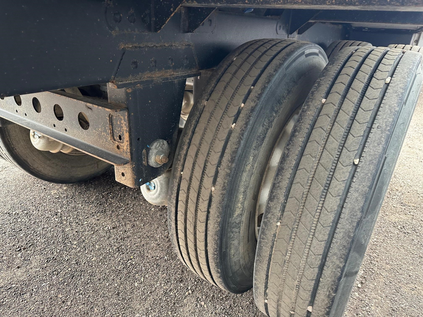 Timpte Super Hopper trailer wheel area with dual tires and suspension visible.