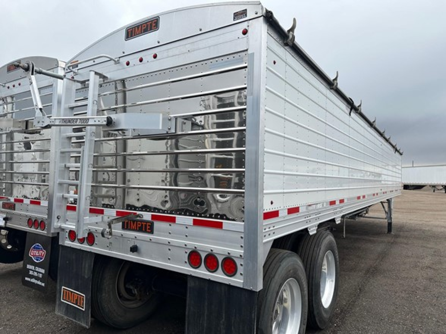 Timpte hopper trailer side view showing 66 inch side and aluminum panels with rear double doors and taillights.