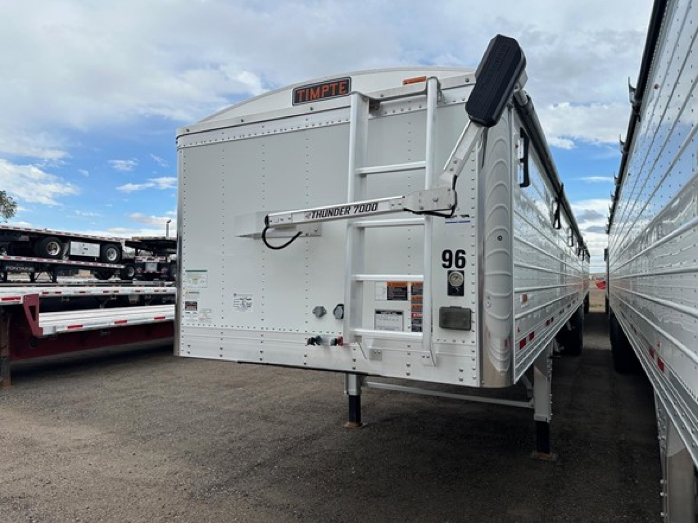 Timpe trailer rear showing Timpte logo, 96 sticker, Thunder 7000 bar, rear latch, and side rail with corrugated metal.