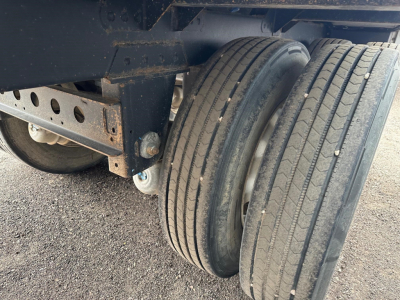 Timpte Super Hopper trailer wheel area with dual tires and suspension visible.