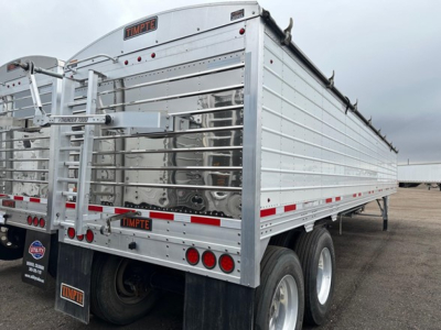 Timpte hopper trailer side view showing 66 inch side and aluminum panels with rear double doors and taillights.
