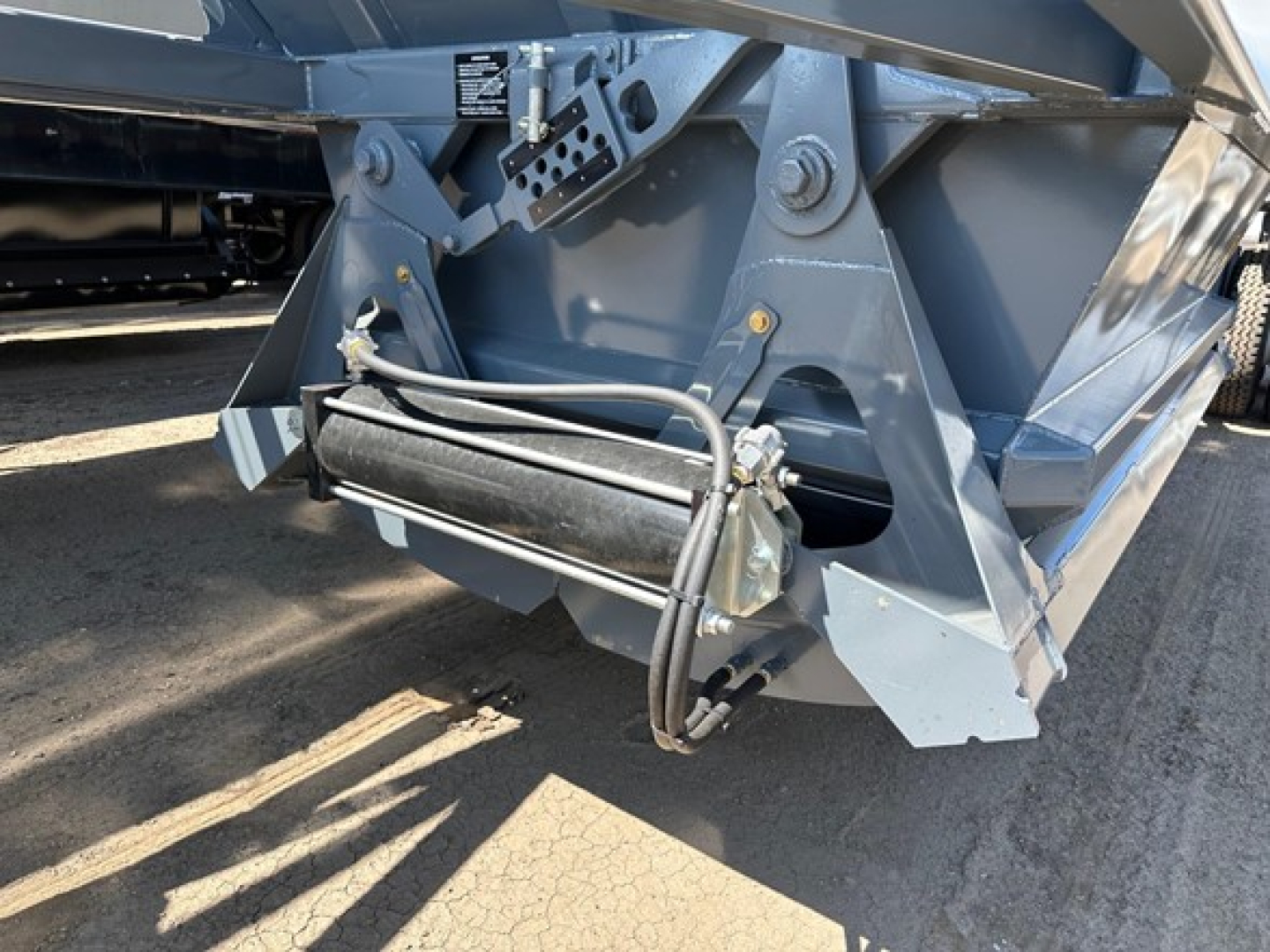 Ranco LW21-40 trailer component showing hydraulic hoses and mounting bracket with metal frame and painted blue finish.