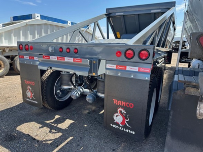 Ranco LW21-40 dump trailer rear view showing mud flaps with Ranco logo and contact number, twin axle, side markers, and tail lights.