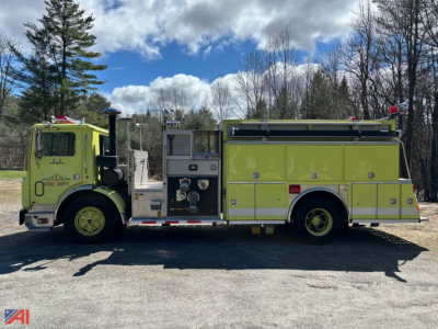 1989 Mack fire truck side view showing bright yellow-green body with compartments, water pump panel, and siren lights.