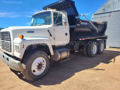 Truck cab and dump body showing Ford LT9000 logo and dump bed with hydraulic lift.