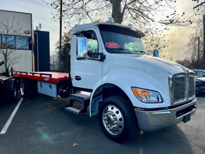 Kenworth T280 tow truck in white, front three-quarter view showing cab with 2025 sticker, side steps, and flatbed behind.
