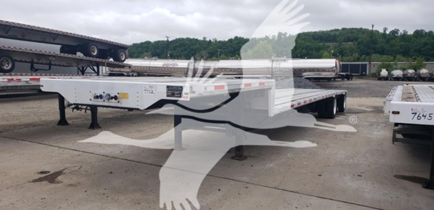 Transcraft D-Eagle II drop deck trailer showing side rails and deck with stock number plate visible.