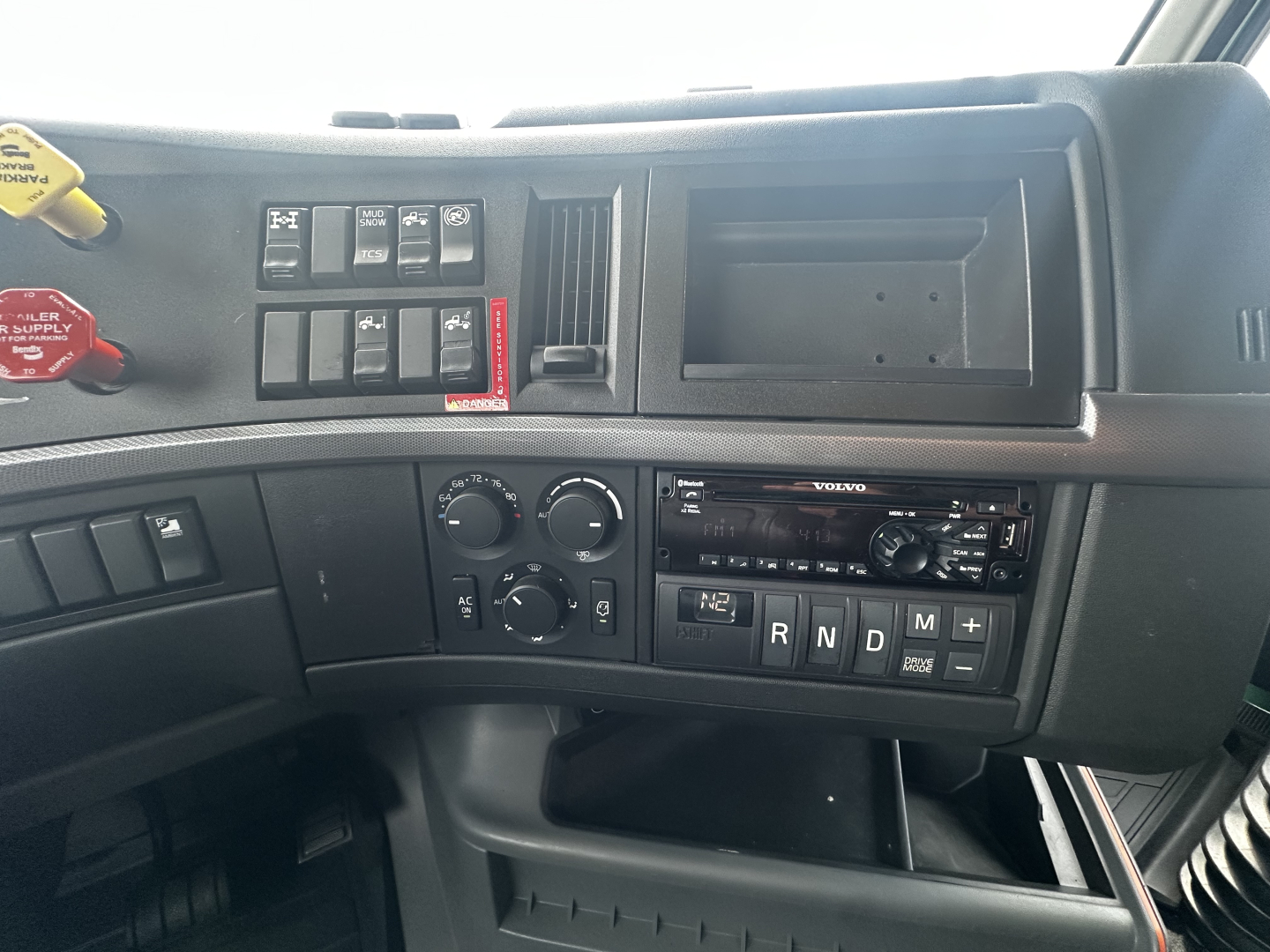 Volvo VNL64T760 dashboard view showing climate controls, gear selector panel, and radio module.