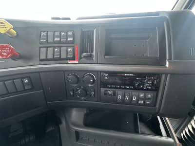 Volvo VNL64T760 dashboard view showing climate controls, gear selector panel, and radio module.