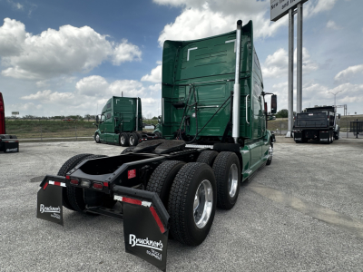 Volvo VNL64T760 sleeper tractor rear view showing chassis, wheels, and fifth wheel with Bruckner's branding mud flaps.