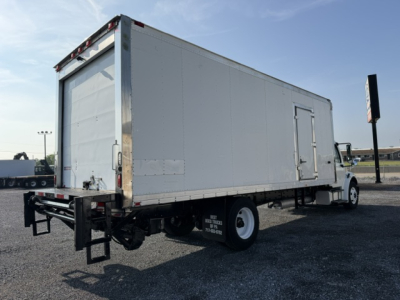 Freightliner M2-106 refrigerated box truck rear/side view showing cargo area and rear doors.