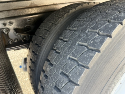 Freightliner M2-106 wheel/tire view showing heavy tread and undercarriage.