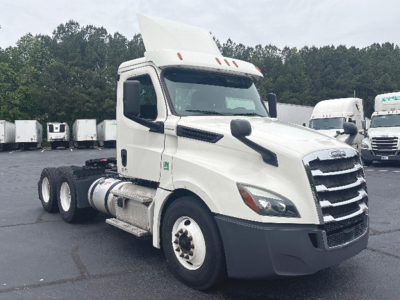 Truck cab showing 2019 Freightliner Cascadia126 with raised hood and dual rear axles, front grille, side mirrors, and fuel tanks.