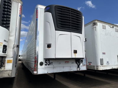 Utility 3000R trailer refrigeration unit mounted on front with white body and black vent, 53 ft decal on curb side, other trailers visible.