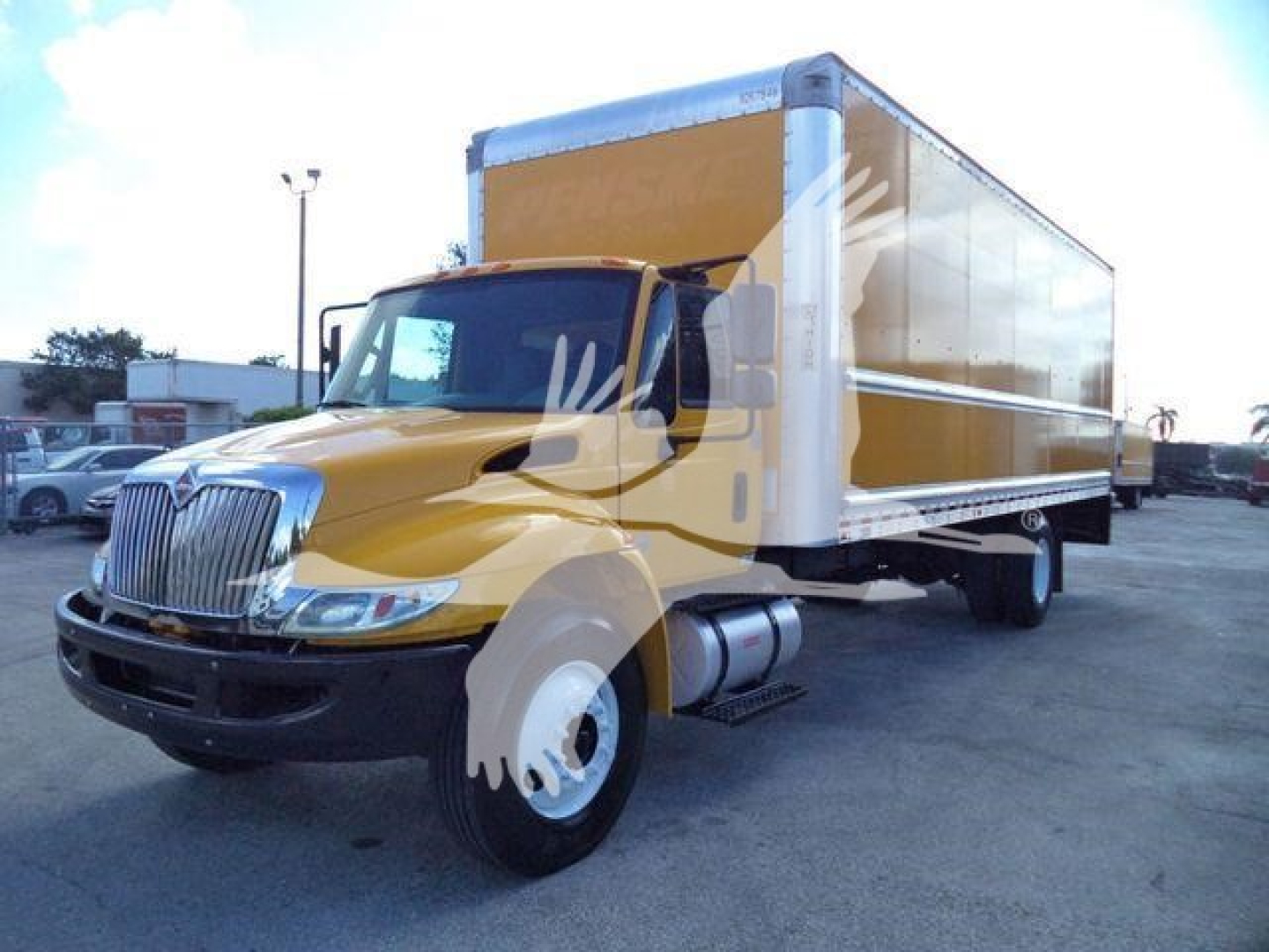 Box truck 2019 International Durastar in-service with yellow cab and large white cargo box, front grille and wheels visible.