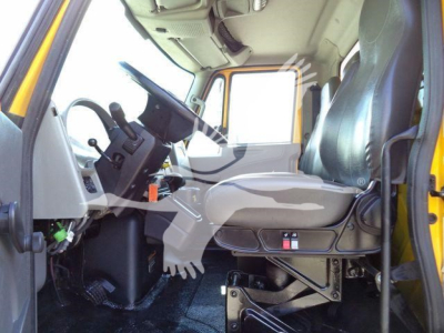 Truck cab interior of a 2019 International Durastar box truck showing driver's seat and steering column.