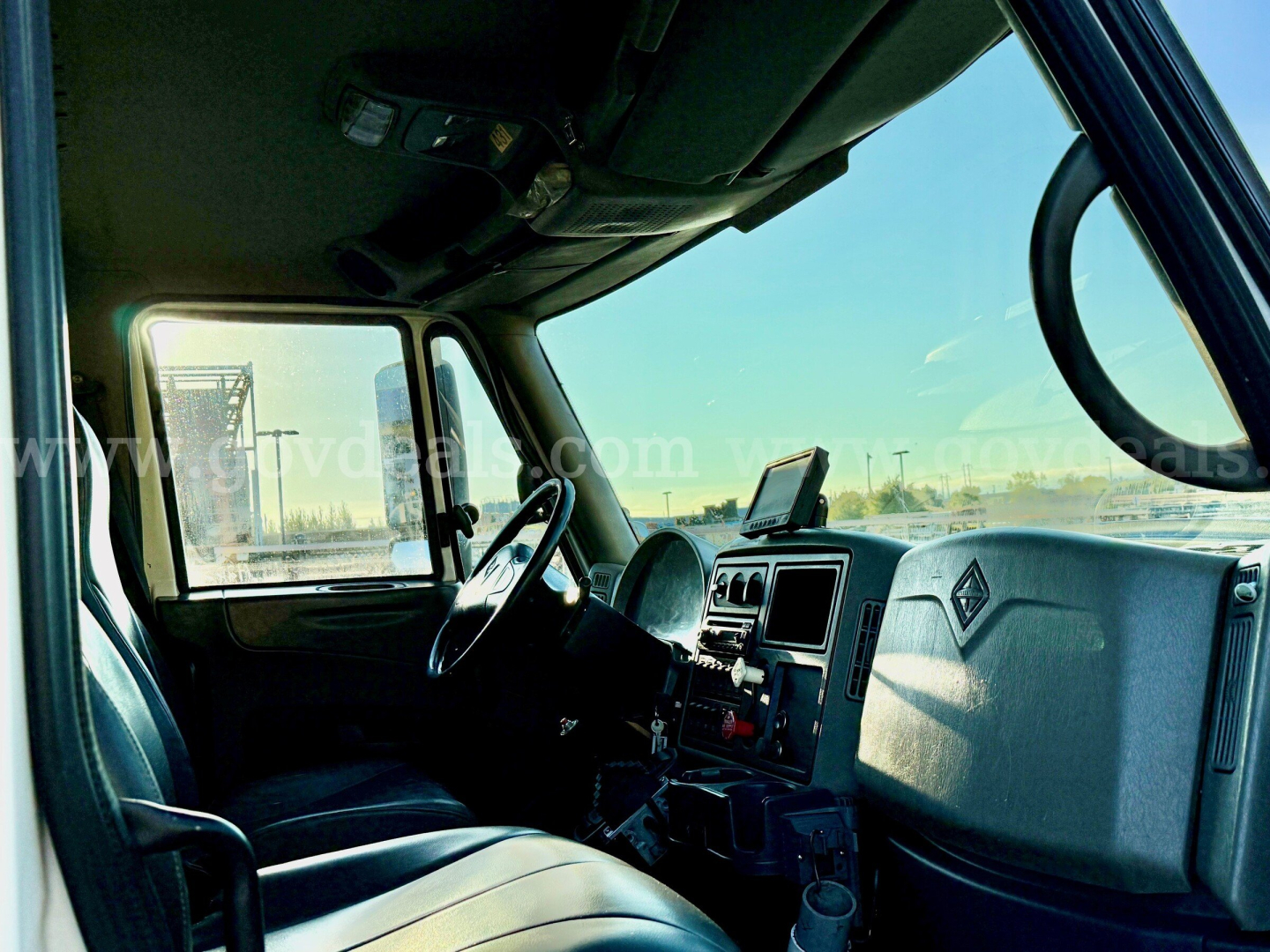 Truck cabin interior of an International 7500 showing dashboard, steering wheel, and driver’s seat.