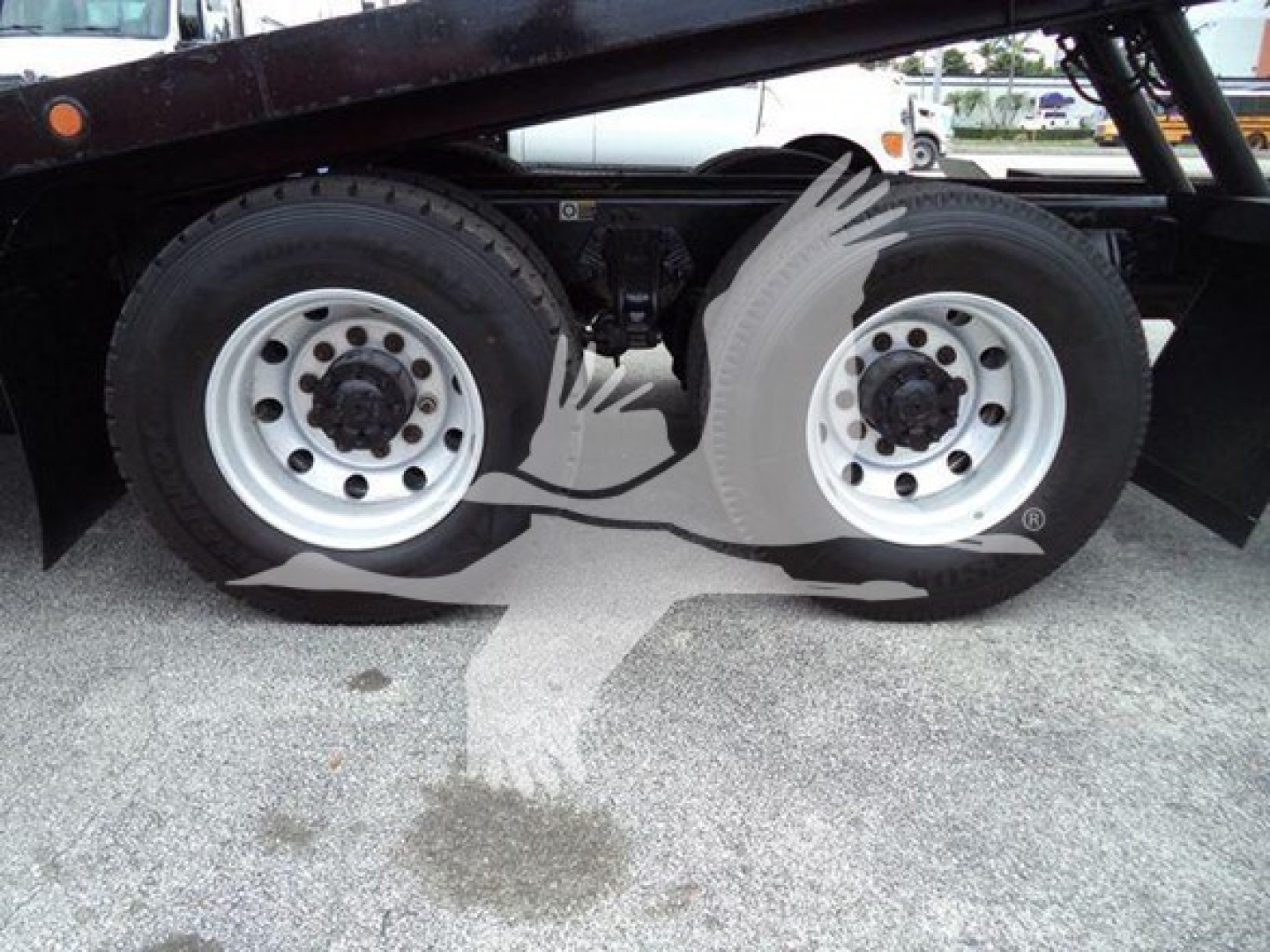 Peterbilt 348 roll-back truck rear wheels and dual-axle suspension with heavy-duty tires and braking assemblies visible.