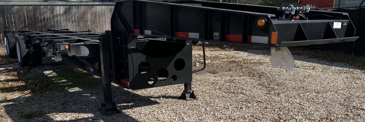 Trailer chassis showing front section of a Pro-Haul 43' sand chassis trailer with support legs and frame. Visible components include leaf spring undercarriage and hitch area.