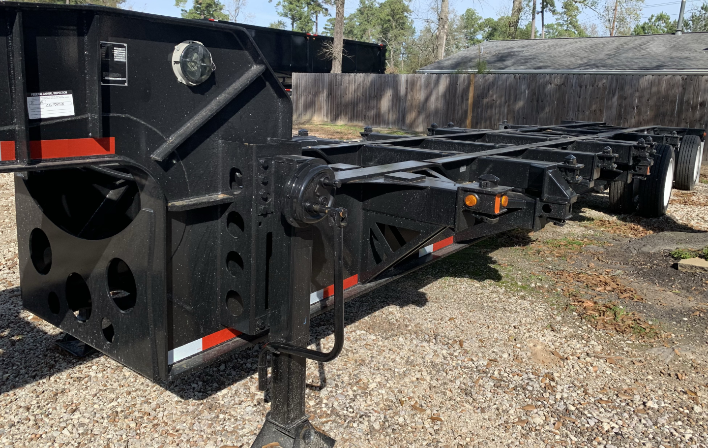 Trailer chassis showing a black Pro-Haul 43' sand chassis with heavy-duty steel frame, front landing gear, and I-beam rails.