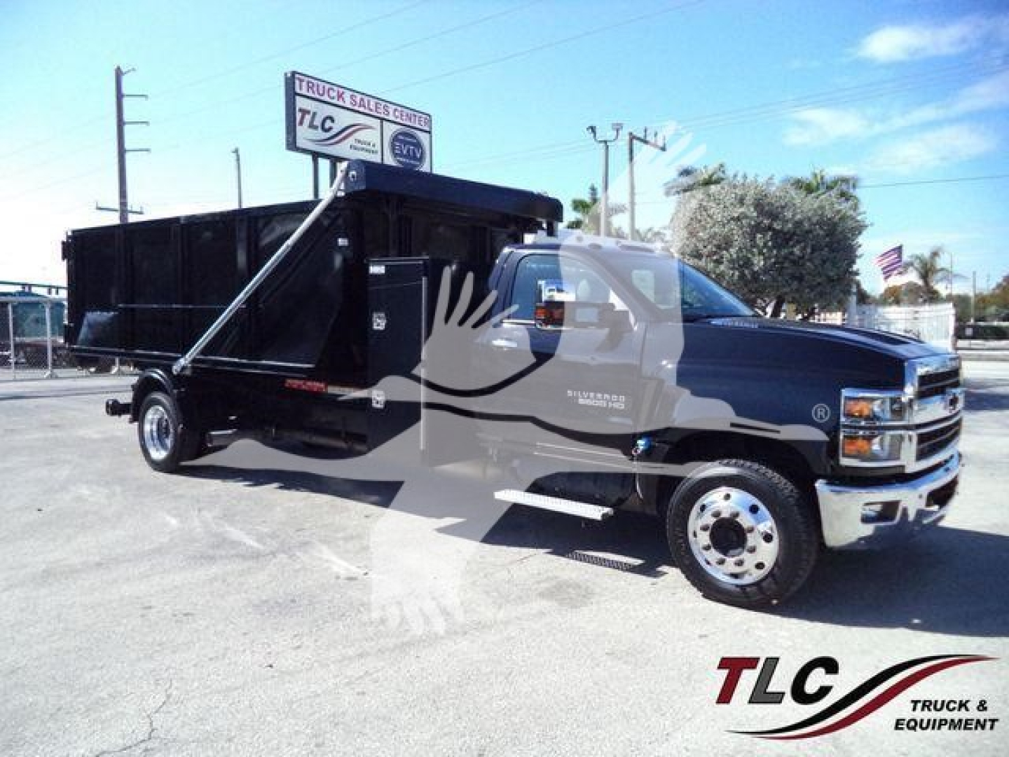 2023 Chevrolet Silverado 6500HD dump truck in a dealership lot with TLC watermark across the image.