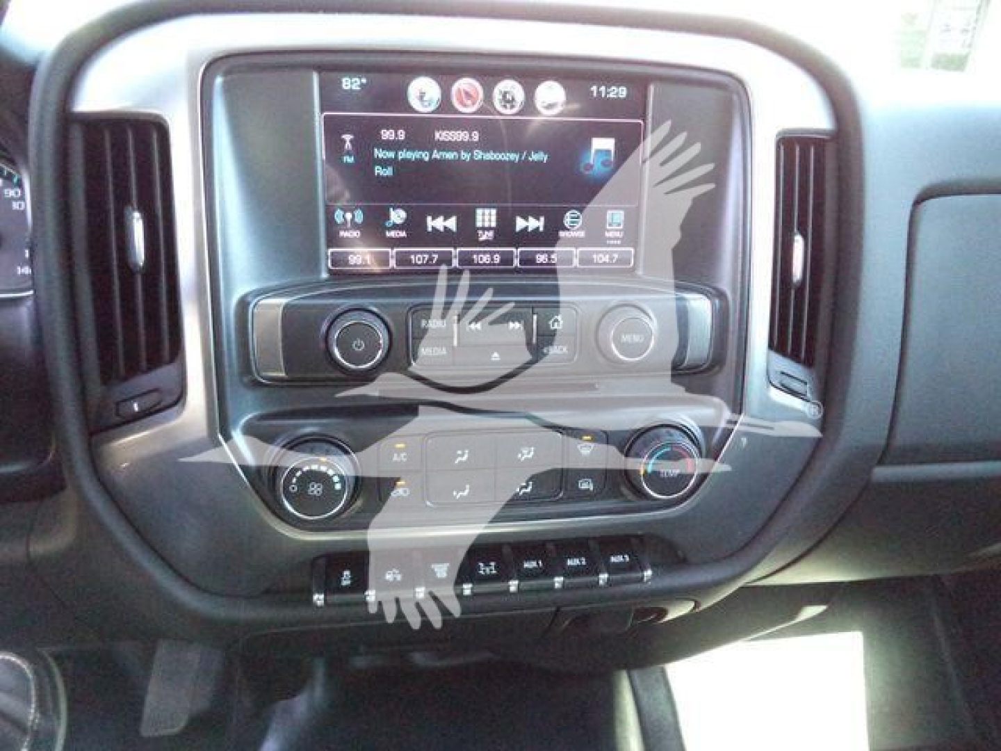 Chevrolet Silverado interior center console with touchscreen display and controls; visible are climate controls, steering wheel, and radio infotainment interface.