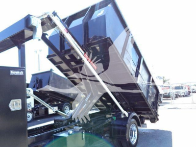 Truck bed with hydraulic ramps and hydraulic arms lifting a dump-style bed. Silverado 6500HD label not visible.