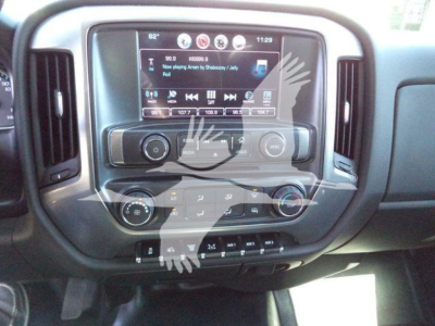 Chevrolet Silverado interior center console with touchscreen display and controls; visible are climate controls, steering wheel, and radio infotainment interface.