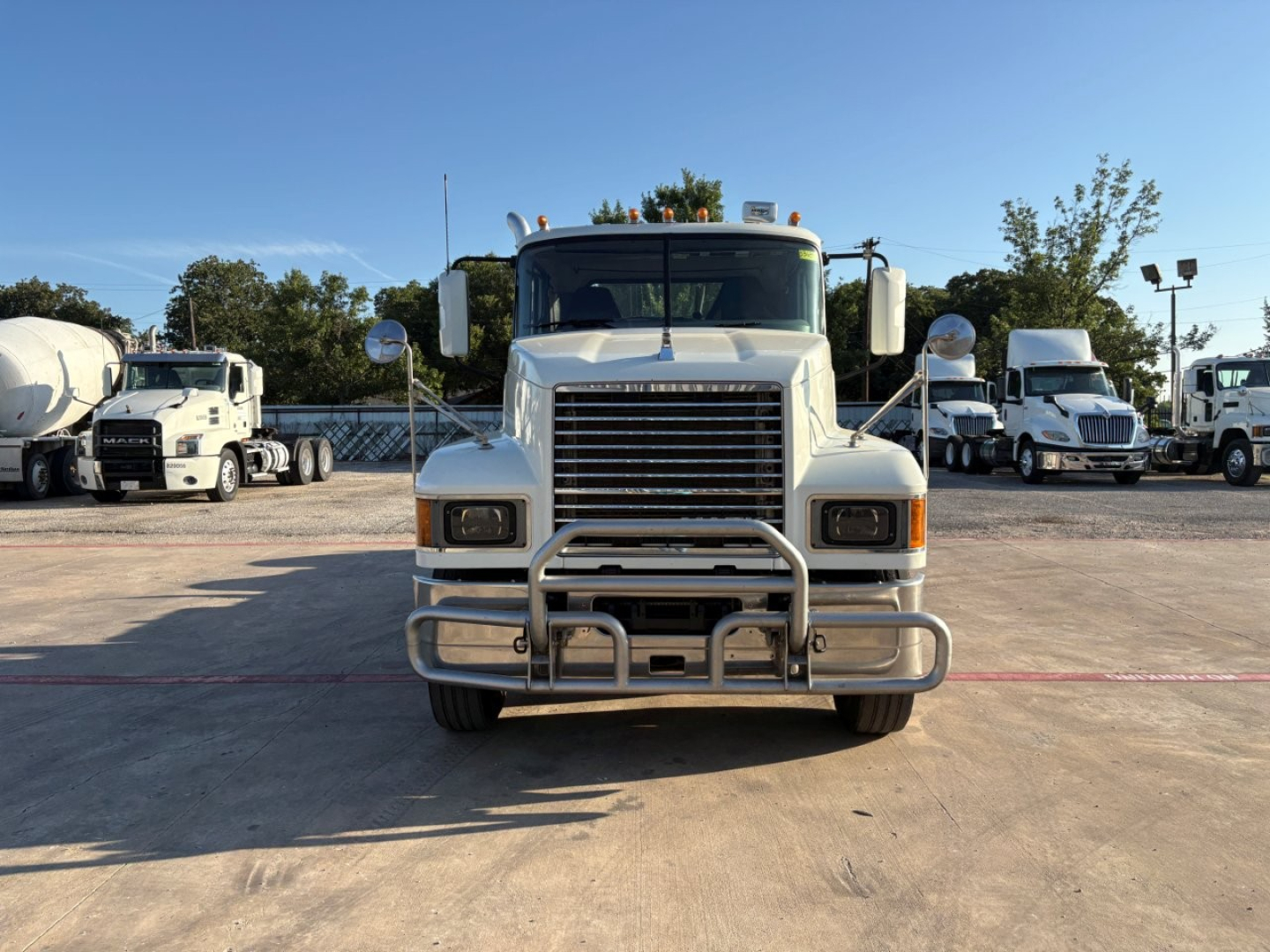 Front view of a 2020 Mack PI64T conventional daycab truck with chrome grille, bumper guard, and large side mirrors.