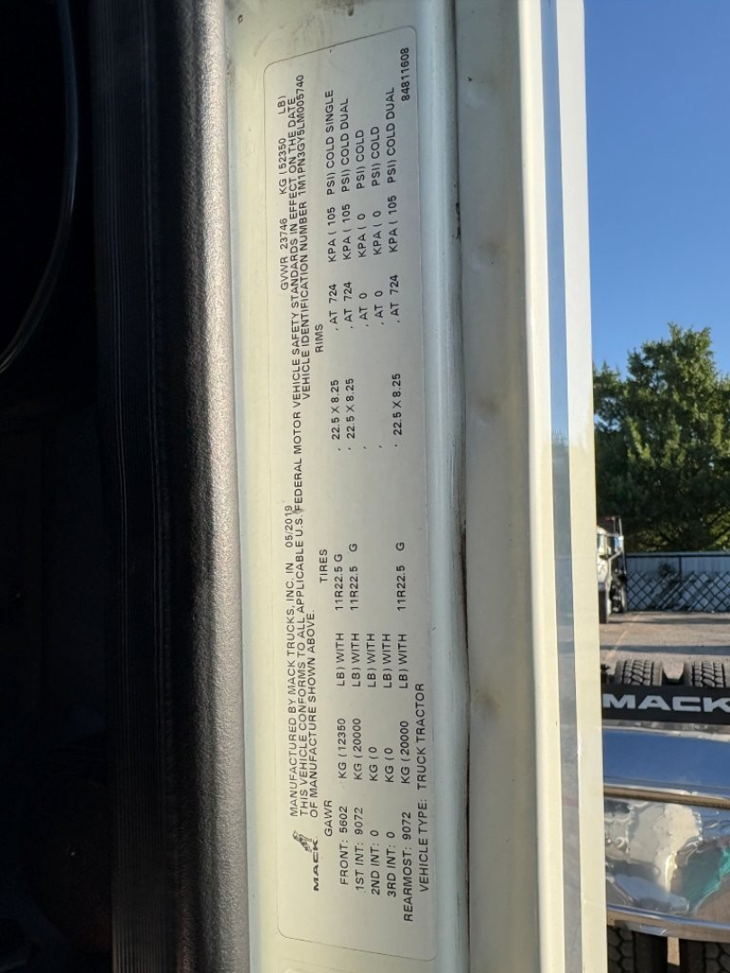 Vehicle data plate on a 2020 Mack PI64T showing VIN, axle and tire information, service codes and weights.