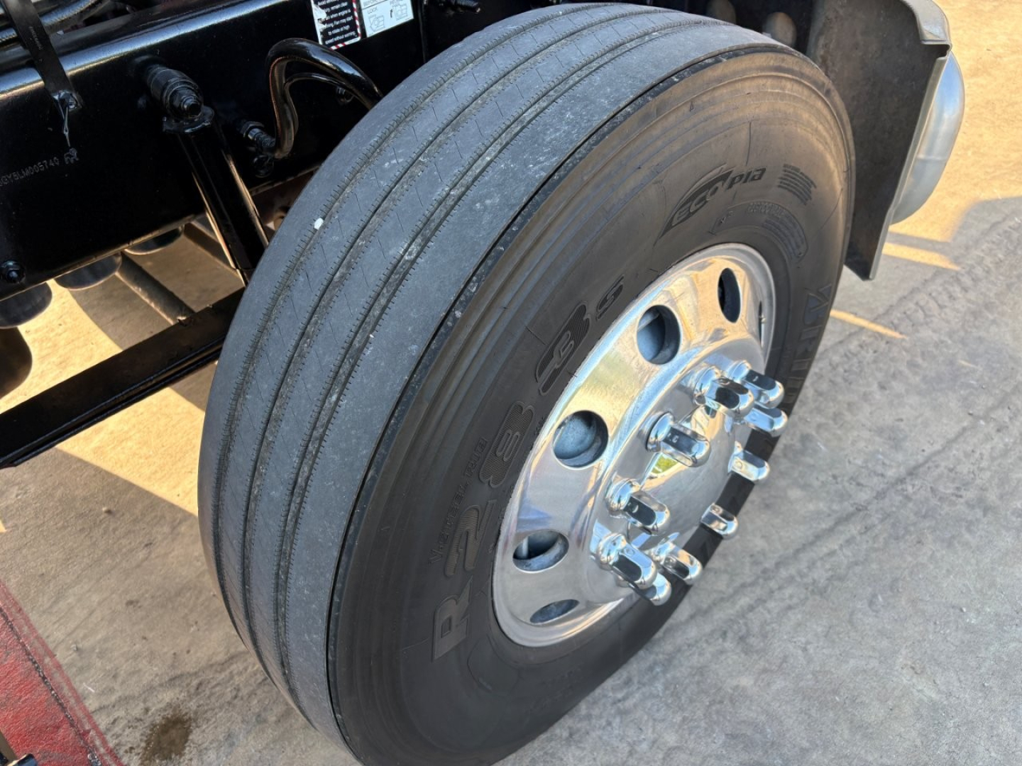 Wheel and tire of a 2020 Mack PI64T daycab showing front dual wheels and chrome lug nuts, with tread and hub visible.