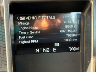 Vehicle totals display on Mack PI64T showing mileage 491927 miles, engine hours 16668.2h, time in service 692d19h0m, fuel used 79286 gal, highest RPM 2333, N N2 E gear indicators.