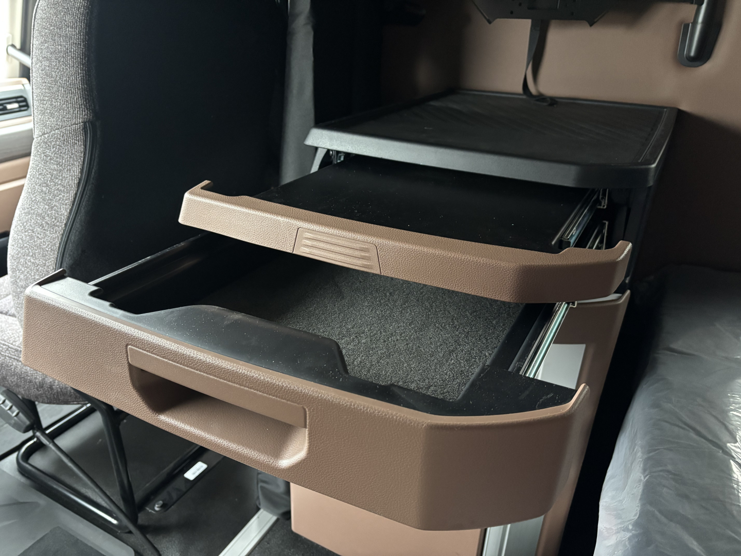 Cab interior showing two open brown storage drawers in a Mack PR64T76M truck cab.