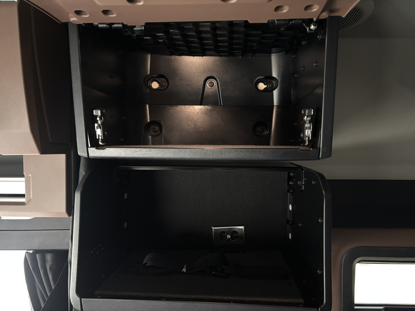 Mack PR64T76M truck cab interior showing storage compartments and dash area with empty overhead bin