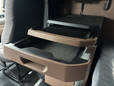 Cab interior showing two open brown storage drawers in a Mack PR64T76M truck cab.