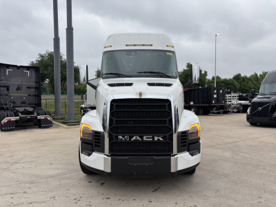Front view of a white Mack truck PR64T76M sleeper cab showing large black grille and amber daytime running lights.